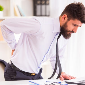 man with back pain needing chiropractic care